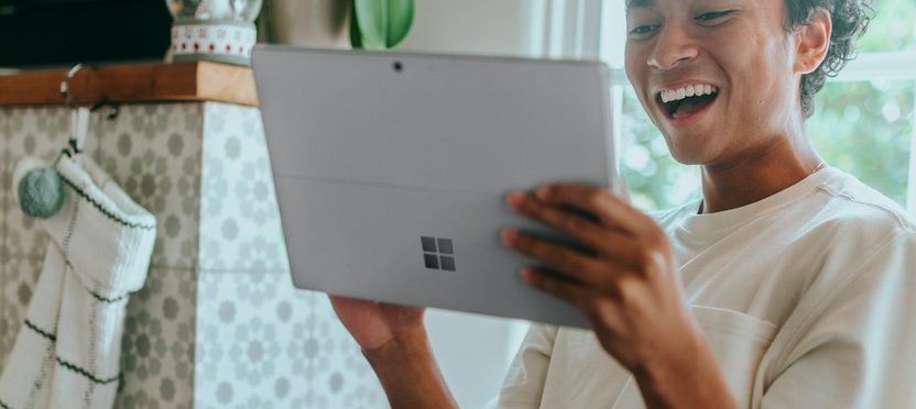 A buyer smiling at a laptop at home