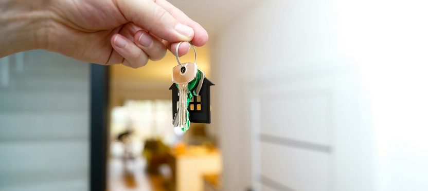 House keys held up at a front door