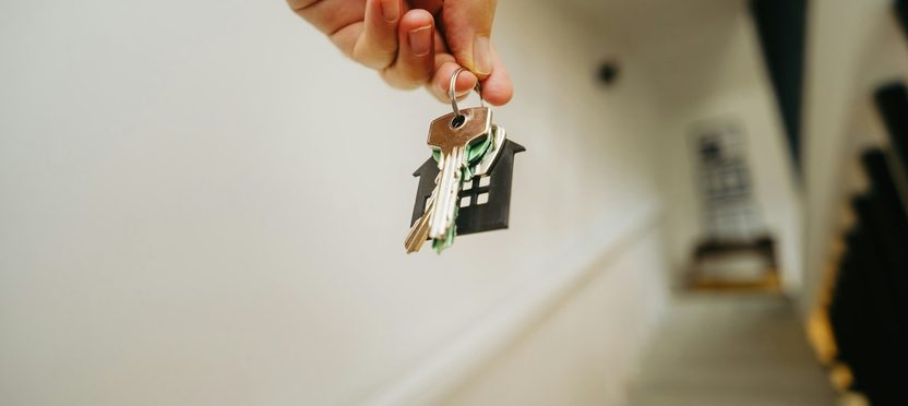 A house key on a keyring in a doorway