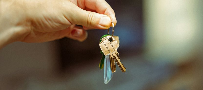Hand holding out a set of keys