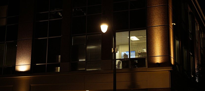 Office building at night with lit windows