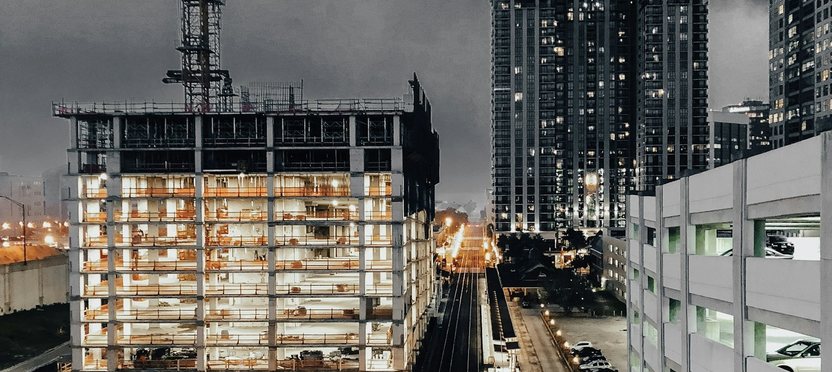 A residential tower under construction at dusk